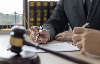 An attorney during a meeting with a client in a legal office.