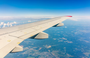 View from the airplane window at a beautiful cloudy sky and the airplane wing