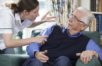 care worker mistreating senior man at home